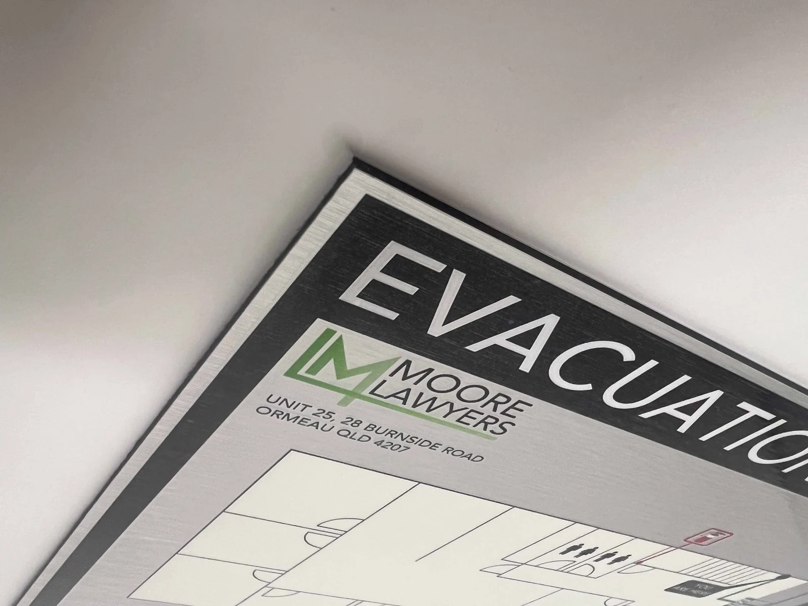 Close-up of an aluminium composite evacuation sign edge